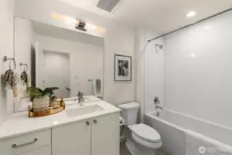 Sophisticated full bath with clean modern finishes and soft ambient lighting for a spa-like feel.