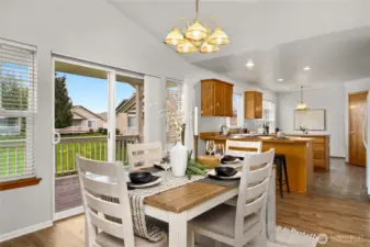 Dining area overlooks the large green space off the back of the home.