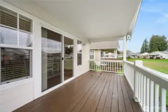 Covered back deck overlooks the green space.