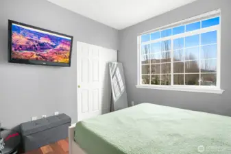 A well-positioned second bedroom and full bath provide flexibility for guests, a home office, or both.