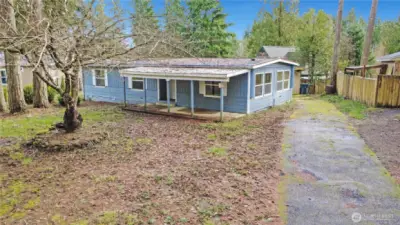 Large covered front porch entry, lifetime metal roof & long paved driveway.