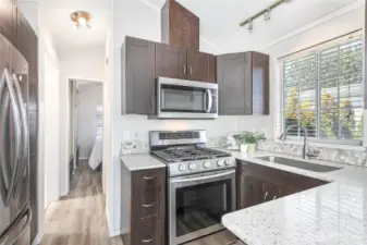 Kitchen was updated few years ago with solid surface counters, stainless steel appliances & nice tile backsplash.
