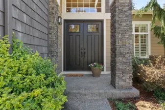 Large entry with double oversized doors and large covered porch.