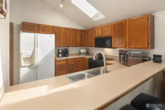 The kitchen has ample counter space and cabinets.  All appliances remain including washer and dryer.