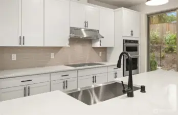 Induction cooktop and stainless steel farmhouse sink