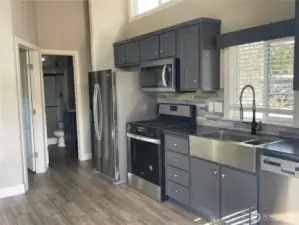 Stepping into the home, check out those appliances! Propane stove by the way