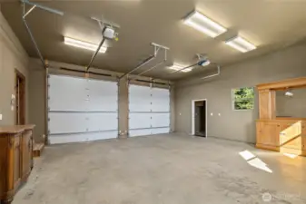 Spacious HEATED garage with  garbage room