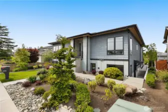 The attached apartment, located on the east side of the home, features its own exterior entrance. Inside, you'll find a spacious layout with one bedroom, one bathroom, a full kitchen, laundry facilities, and a comfortable living room.