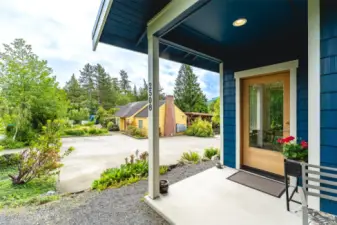 Front door with view of common house and parking