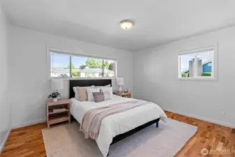 PRIMARY BEDROOM | This sweet room is located at the front of the home and features hardwood floors and fresh paint.