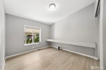 3rd bedroom with built in media shelves. Previously used as a gaming center. Could make a great guest room and office space.