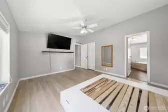 Primary bedroom with bed frame and TV that both stay.