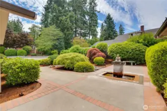 Entrance off the parking area with water feature.
