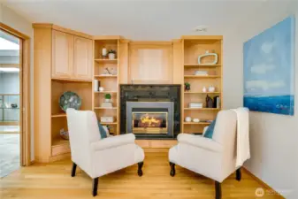 Other half of the nook off the kitchen with gas fireplace & additional custom cabinets.