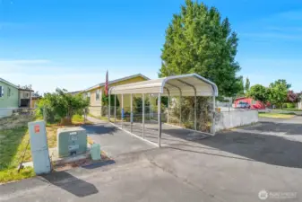 This lot features a metal carport to keep your car in the shade, out of the heat and winter snow.