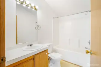 The brightly lit, main bathroom has everything you need and all that extra counter space.