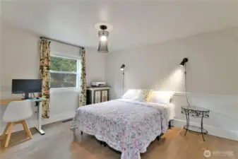 Bedroom 2 : Bright and inviting—southeast-facing bedroom with backyard views and stylish barn door closet.