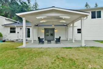 Gather in comfort—covered backyard space with skylights perfect for any weather.