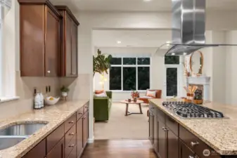 Gas cooking with hood, granite counters, and extra tall cabinets.