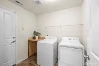 Laundry and mud room just off garage. Washer and dryer stay! You will love the space in the garage.