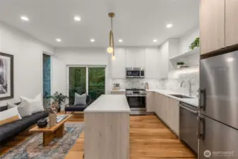 Sleek quartz countertops, premium stainless steel appliances, and a floating island made for casual mornings.