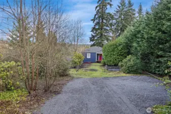 Big front yard and gravel driveway area for parking