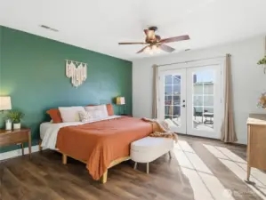 primary bedroom with french doors to backyard