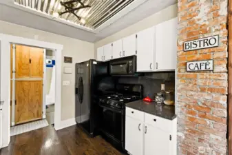 Kitchen showing gas stove and double door refrigerator