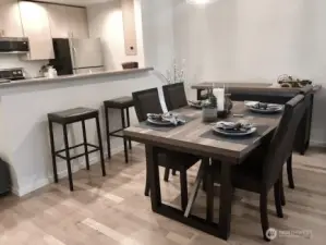 Dining nestled between the kitchen & livingroom along with an eat at bar