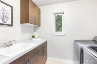 Laundry room with convenient utility sink on upper level.