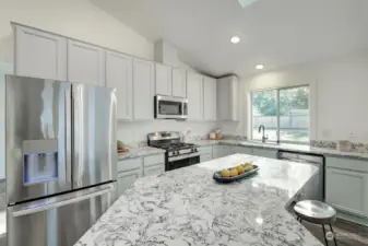 Kitchen has lots of cabinet and countertop space.