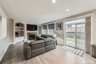 A fireplace flanked by built-ins invites relaxation in the family room.