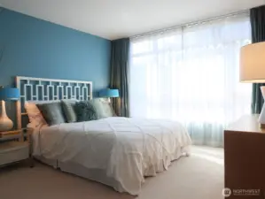 Very spacious primary bedroom with luxurious silk drapery to provide privacy.