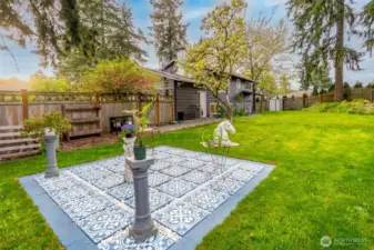 A fully fenced yard with lush green grass for pets and little ones to safely play.