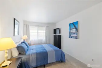 Primary Bedroom with New Carpeting.  Large window for natural light. The TV and Dresser are included with Furniture.