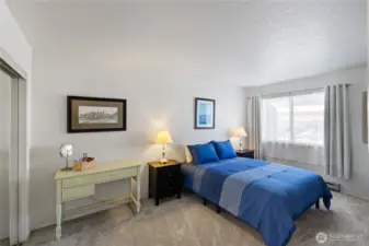 Primary Bedroom with Desk.  All Furniture is included.  The Mirrored closet is on the left.