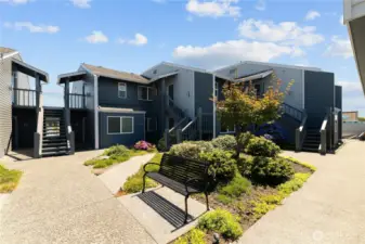 Lovely courtyard with a fountain and seating area.  The building o9n the right is the shared garage.
