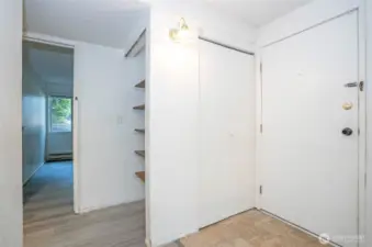 Welcoming entryway with a convenient closet and nearby shelving for added storage.