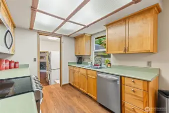 Kitchen looking towards laundry room and Family room in the distance