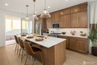 Warm wood finish cabinetry with brass accents. Elegant full height cabinets in kitchen.