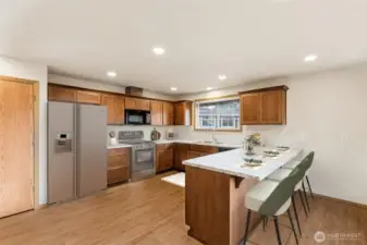Updated kitchen with new shaker cabinets, new LVP flooring, eat in bar & pantry.