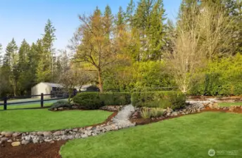 Nestled on 4 usable acres, this estate has been professionally landscaped with a full sprinkler system