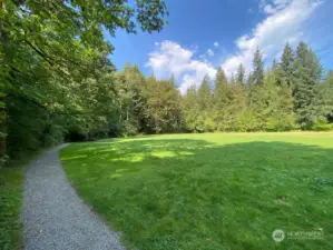 Huge circular playfield surrounded by gravel pathway inside the park