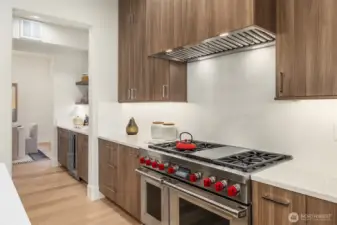 Sub-Zero refrigerator, Wolf six-burner range and Stainless steel Asko dishwasher.