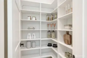 Walk-In Pantry with ample built-in shelving provides extensive storage for all your kitchen essentials.