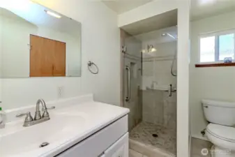 Primary 3/4 bathroom w/tile entry.