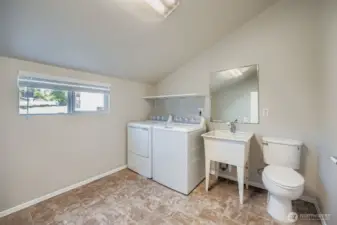 huge laundry room with 1/2 bath could be used for hobbies or sewing room too