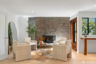 Charming sitting room off the kitchen featuring one of 3 wood burning fireplaces.