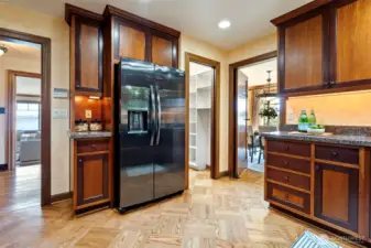 Smart kitchen with tons of storage - large pantry to the right of the refrigerator.
