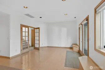 Beautifully spacious family room with built in seats are also convenient storage spaces.